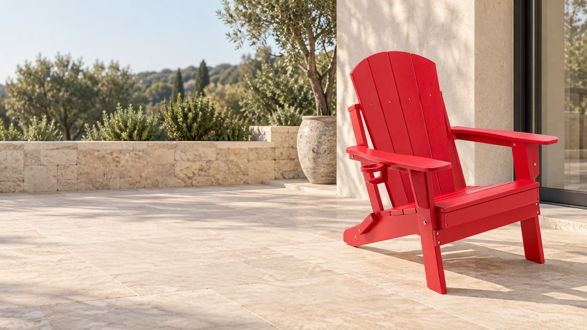 Red foldable HDPE Adirondack chair in a considered outdoor setting