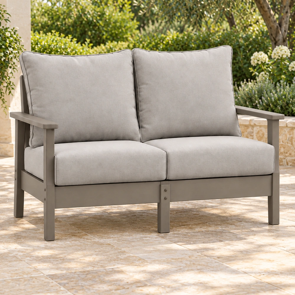 Two-seat cushioned HDPE outdoor sofa on a covered garden terrace