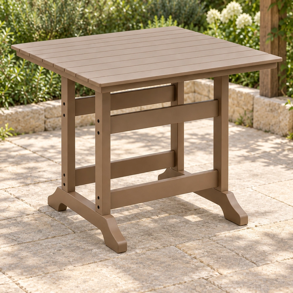 Front-left view of the taupe square trestle-base HDPE dining table on a dry limestone garden terrace